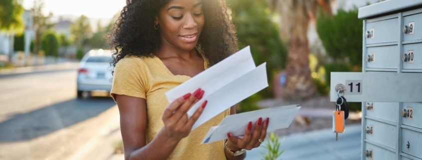 Crush Your Revenue Goals With a Direct Mail Campaign woman checkin her mailbox web