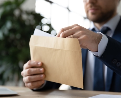How to increase donations man in suit opening a yellow envelope web