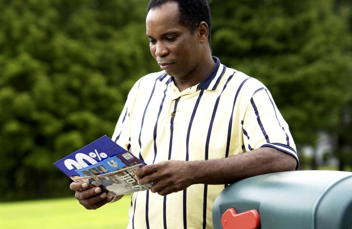 Personalized Direct Mail gets results African American Man looking at mail by mailbox One Stop Mail web