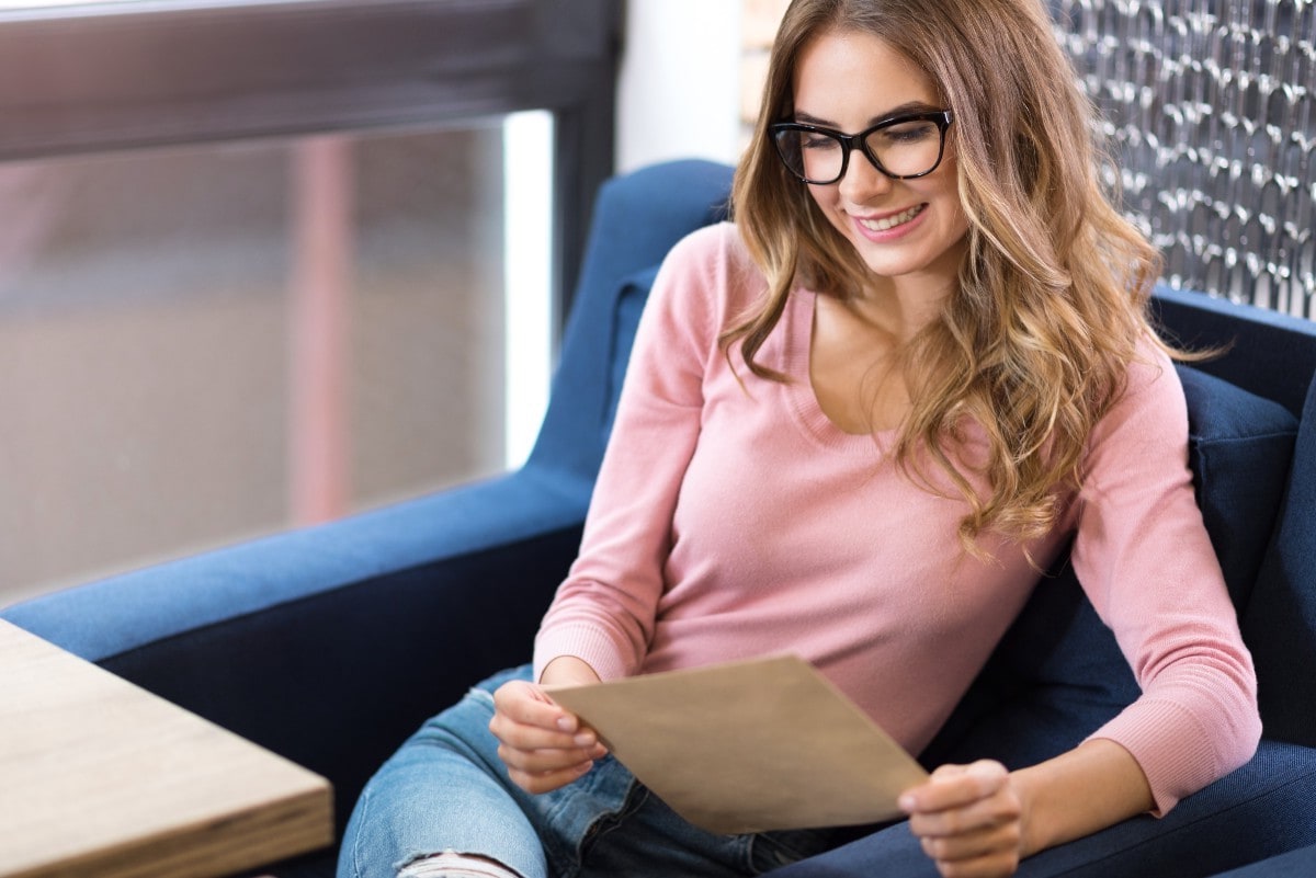 Debt Consolidation List millenial woman with glasses holding letter 1