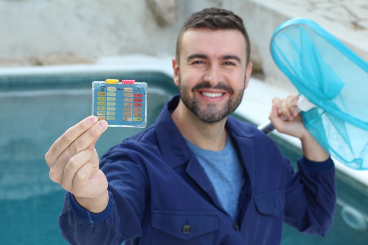 Pool Service Marketing Tips with pool service man cleaning and checking PH level of pool One Stop Mail web