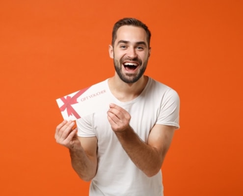 direct mail coupons man holding gift voucher