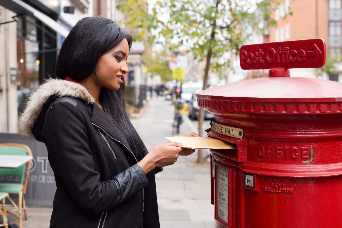 direct mail fundraising woman posting a letter